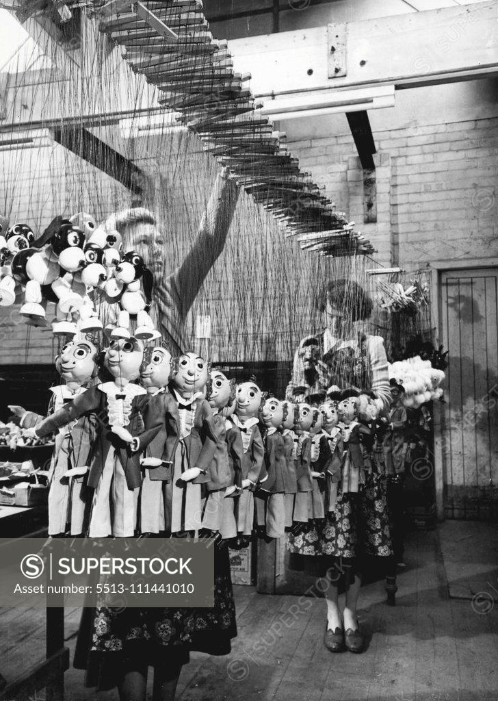 Stock Photo: 5513-111441010 Testing Time For Puppets -- Undergoing a final check before proceeding to the dispatch department are a batch of puppets made in the Wiltshire market town of Marlborough, Here, at the only factory of its kind in England, a group of enthusiastic workers produce the Pelham hand-made puppets, which, in the past five years have found their way into almost ever country in the world, while others have become familiar to Television viewers in Britain. Some of those in this picture will go into British