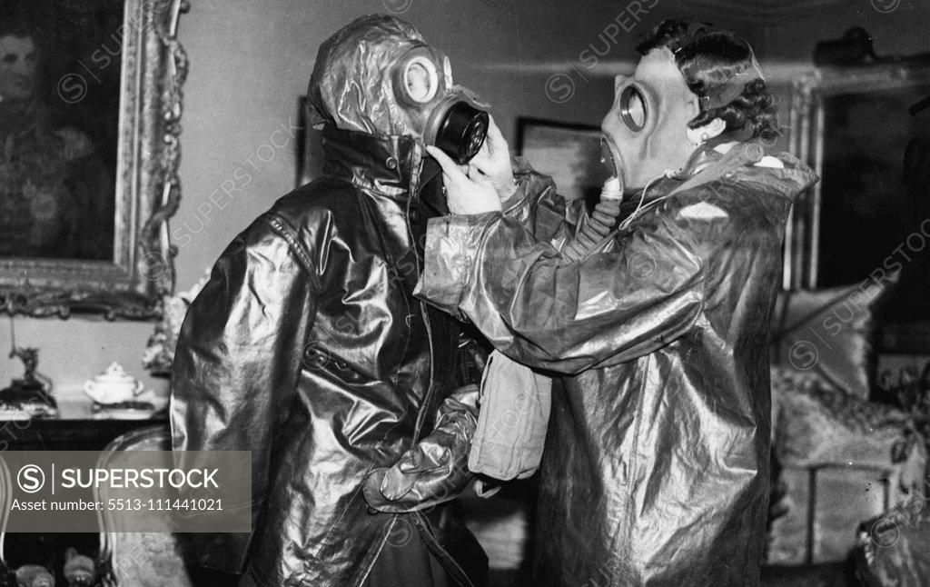 Stock Photo: 5513-111441021 Mayfair Tea Party In Gasmasks - Mrs.Fitzmaurice Of Orkney, and Lady Elibank. Society ladies at a Mayfair tea party donned gasmasks and decontamination clothes when they were instructed on Air Raid precautions and shown to use the equipment, The demonstration was arranged by Mrs.Fitzmaurice of Anna, one of the most energetic of the A.H.P. workers in social circles,and Mr.White Knox. April 4, 1938. (Photo by London News Agency Photos Ltd.).