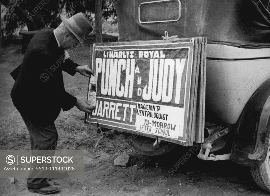 Stock Photo: 5513-111441028 The ***** clips his sign on the back of the car. September 26, 1952.