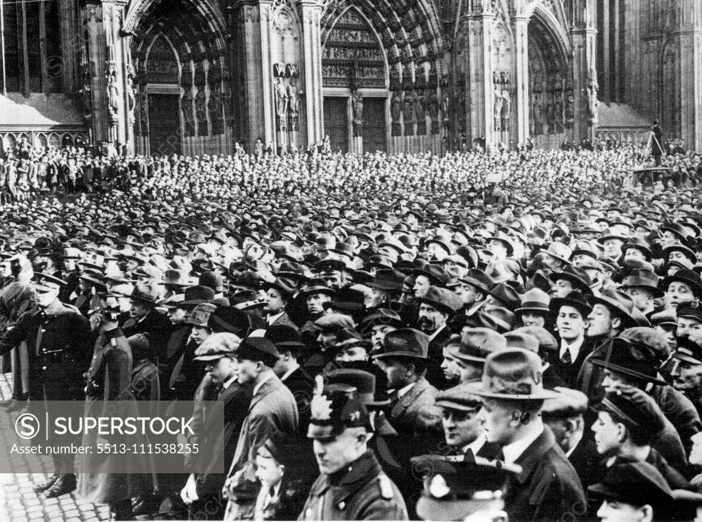 Stock Photo: 5513-111538255 The British Flag Hauled Down in Cologne After Seven Years' Occupation: The huge crowd in the streets outside Cologne Cathedral during the ceremony. Note the British soldiers and German Police in charge together in front of the crowd. January 1, 1929. (Photo by Central News).