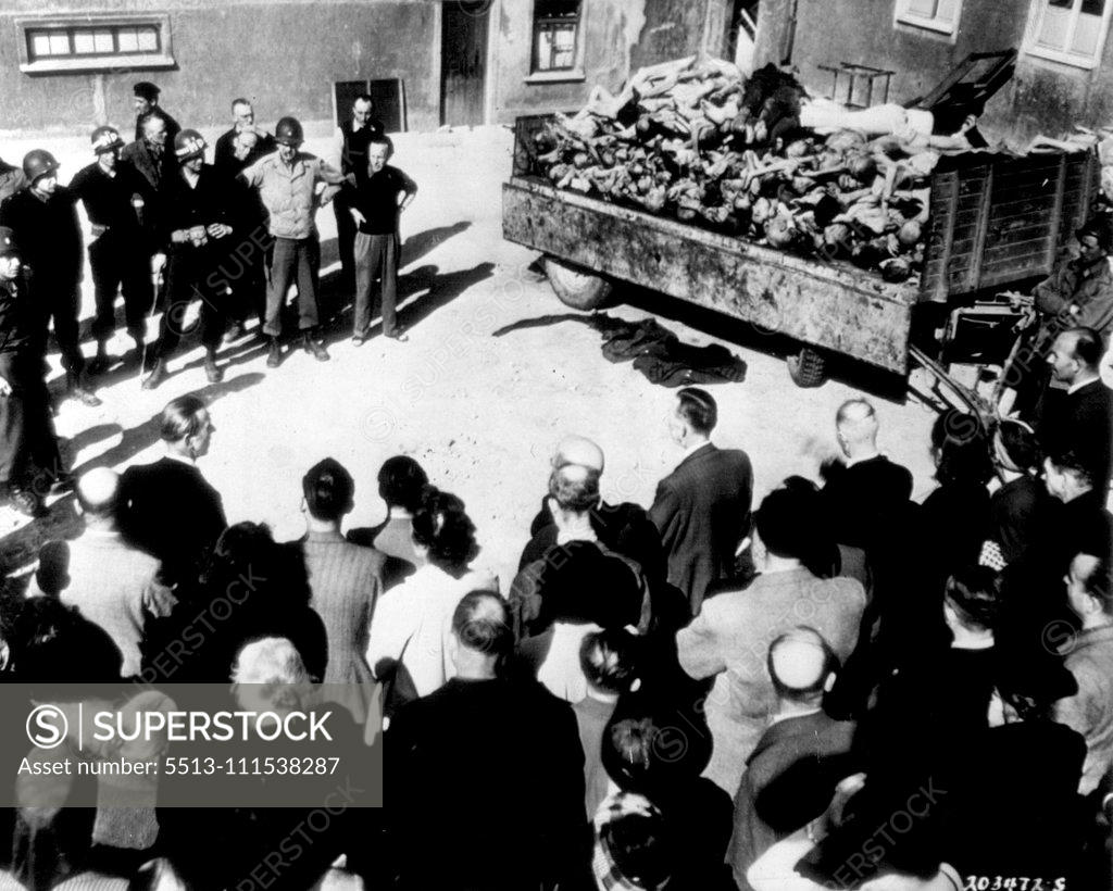 Stock Photo: 5513-111538287 German Civilians See Truckload of Bodies - Civilians in the German city of Weimar are forced by U.S. 3rd Army Military Police (left background) to see a truckload of dead prisoners at Buchenwald, the nearby Nazi Atrocity camp. April 25, 1945. (Photo by AP Wirephoto).