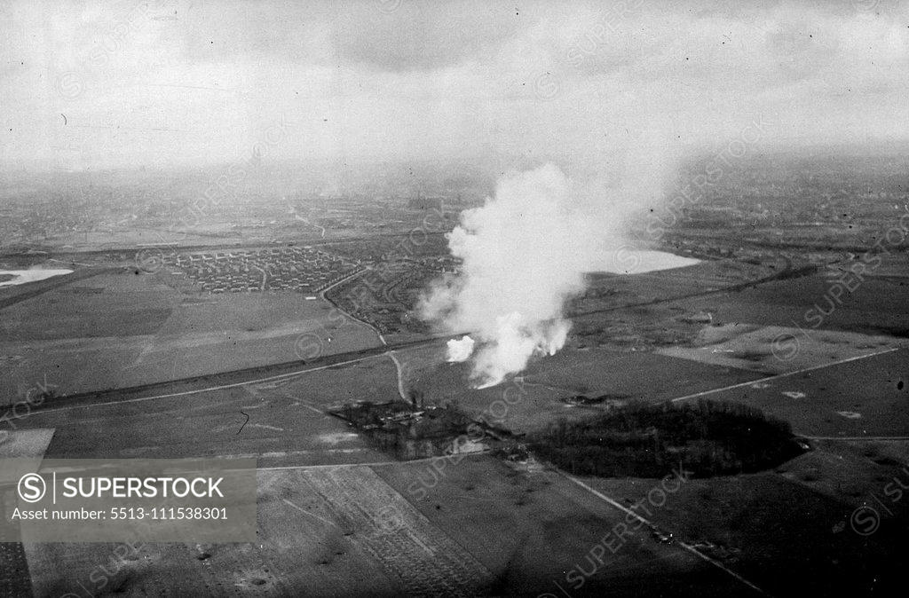 Stock Photo: 5513-111538301 Cologne: These air pictures taken on (5.3.45) by an RAF official photographer of Cologne, which has been entered by U.S. troops show the scene two miles outside Cologne as smoke from bursting marker shells drifts across the countryside. Standing out from the heavy smoke pall is Cologne Cathedral in the far distance. March 1, 1945. (Photo by British Official Photo).