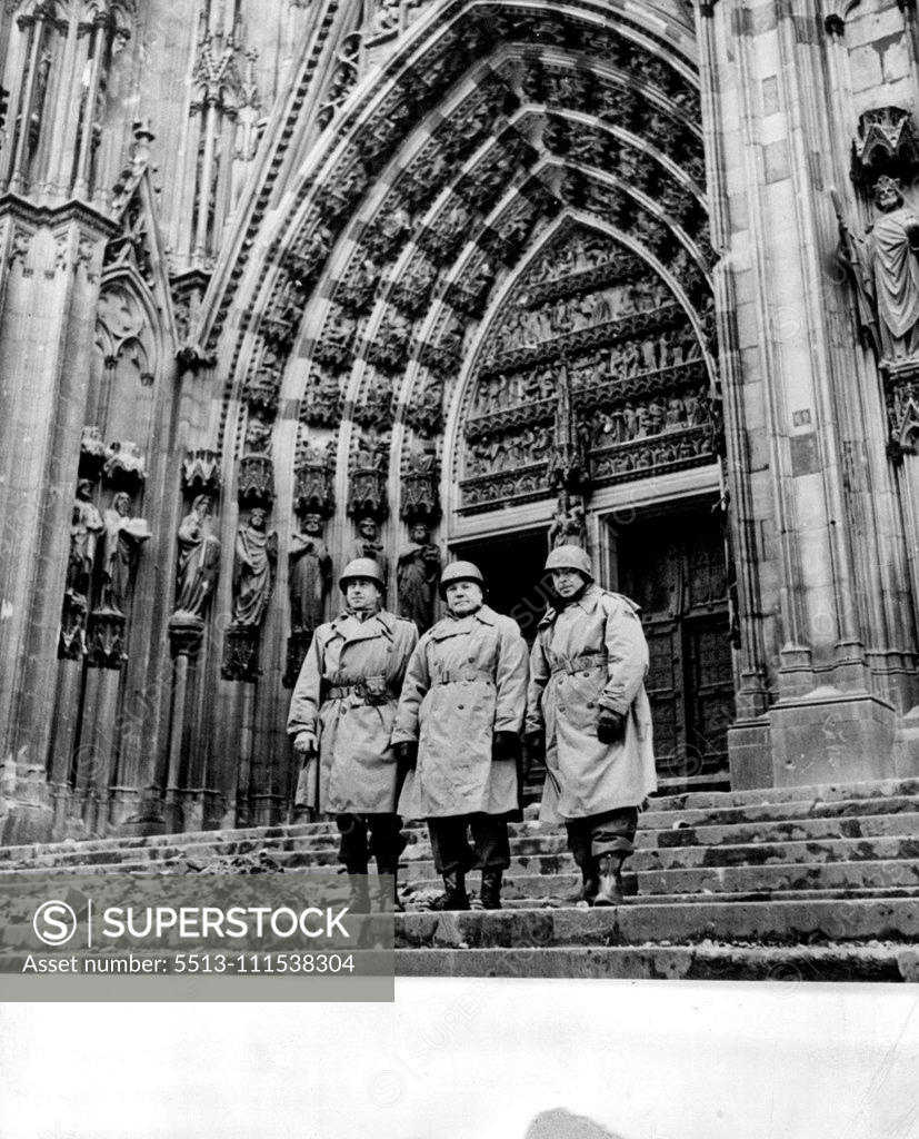 Stock Photo: 5513-111538304 Allied Officers on Steps of Unscathed Cathedral: The American officers stand on the steps of the virtually unscathed Cologne Cathedral, Cologne, Germany. Except for Minor scars the dom's decorated Gothic facade was not marred when American forces captured the German industrial city. The officers (left to right) Maj. Gen. Maurice Rose; Brig. Gen. Doyle Hickey and Brig. Gen. Truman Buoinot, all of the third division. March 15, 1945. (Photo by Associated Press Photo).