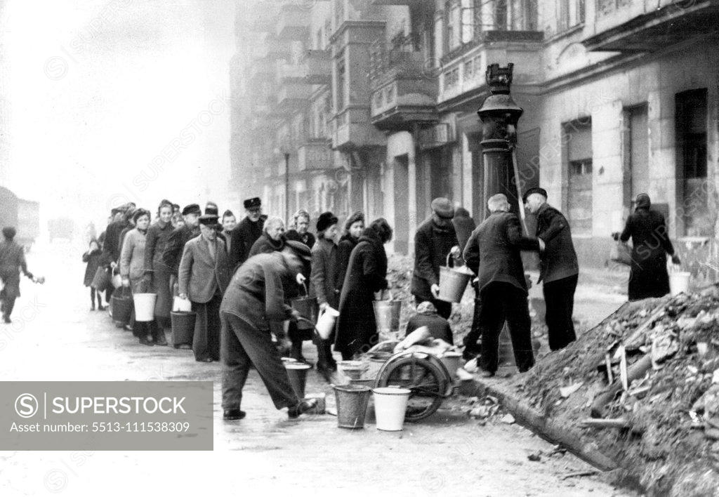 Stock Photo: 5513-111538309 Berliner Line Up For Water: Berliners stand in front of a water pump on a street, waiting to fill their pails during the last days before the fall of the German capital. There were line at these pumps day and night during the last days of the city, since the only available water supply was the foul, unclean water from these wells. July 31, 1945. (Photo by Associated Press Photo).