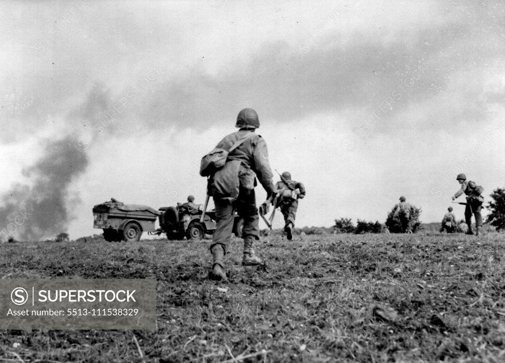 Stock Photo: 5513-111538329 Yanks Dent Siegfried Line: Preceded by heavy air support, U.S. first Army infantrymen, pressing toward the German border, attack Siegfried line defenses in the Aachen area of Holland. Rising smoke in Background indicates bomb bursts from allied planes. August 10, 1944. (Photo by Harry Harris, Associated Press Photo).