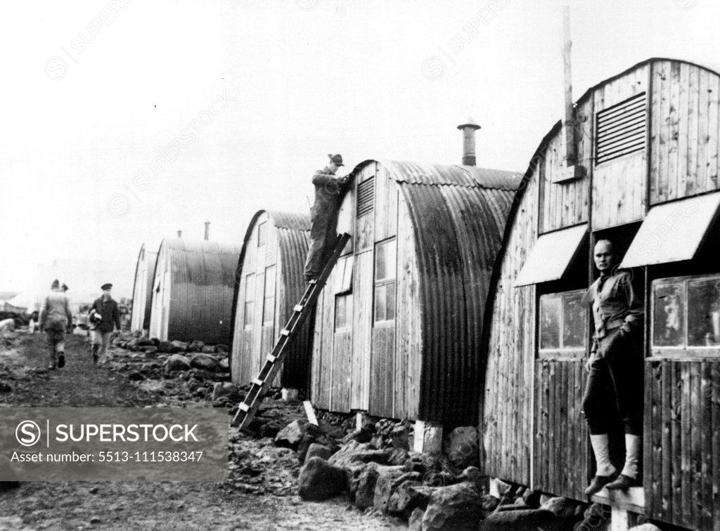 Stock Photo: 5513-111538347 U.S. Marine with 'Situation Well in Hand' Iceland - This U.S. marine at work on a Nissen hut seems to have the situation well in hand as he applies the finishing touches. Official U.S. Navy Photo released yesterday in Washington shows scene in camp near Reykjavik, in American defended Iceland. October 17, 1941. (Photo by ACME).