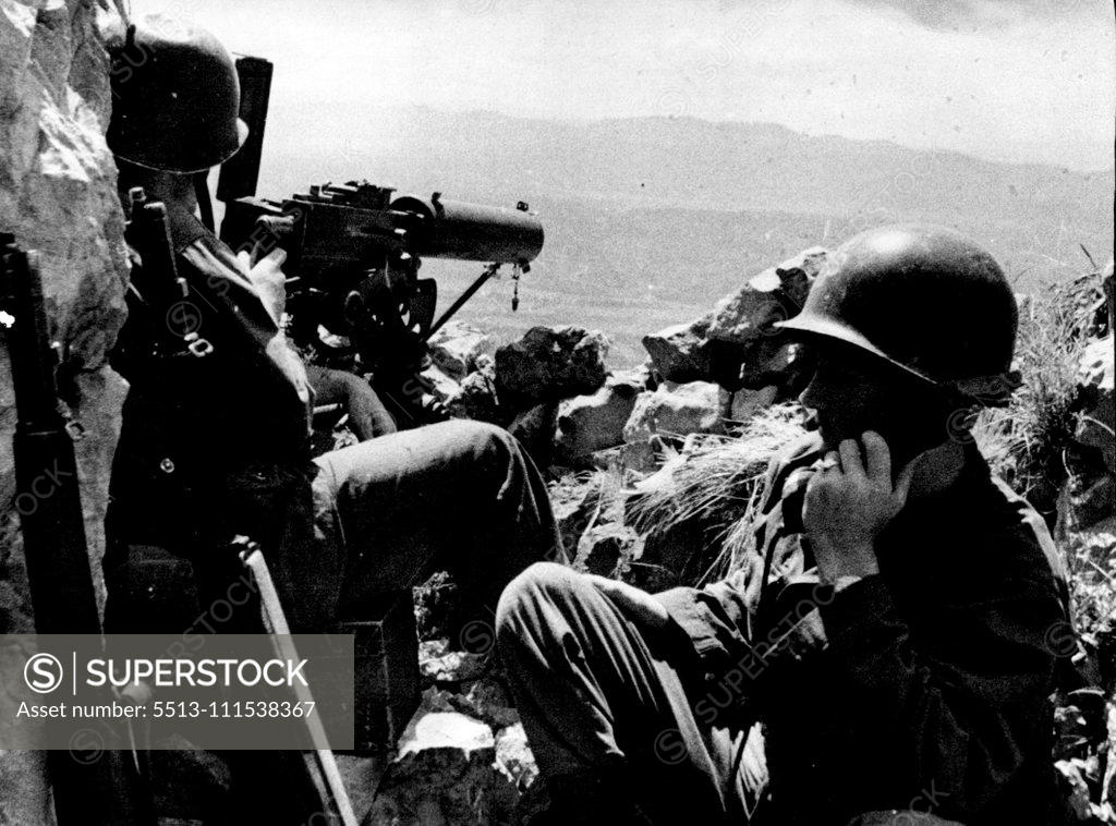 Stock Photo: 5513-111538367 On Guard in Trieste Area: American soldiers stand guard with a mounted machine gun at an observation post in the mountains near Trieste. The port is still paralyzed by a general strike which has been declared illegal by allied military authorities. June 7, 1946. (Photo by Associated Press-Paramount News Photo).