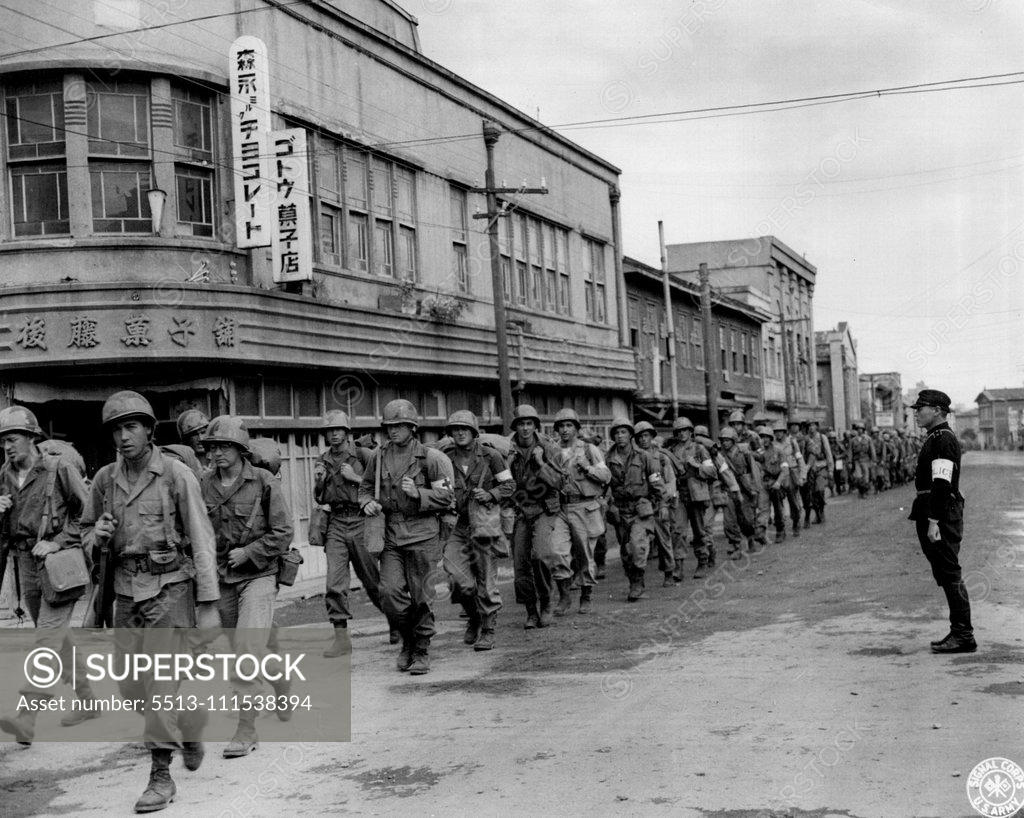 Stock Photo: 5513-111538394 Occupation troops, of the 81st Infantry Division, march into Hirosaki, nead Aomori, Japan, with a Japanese policeman to guide them into the city. Scenes such as this, are typical as the American Forces' take up their zones of occupation. February 25, 1946. (Photo by US Signal Corps Photo).