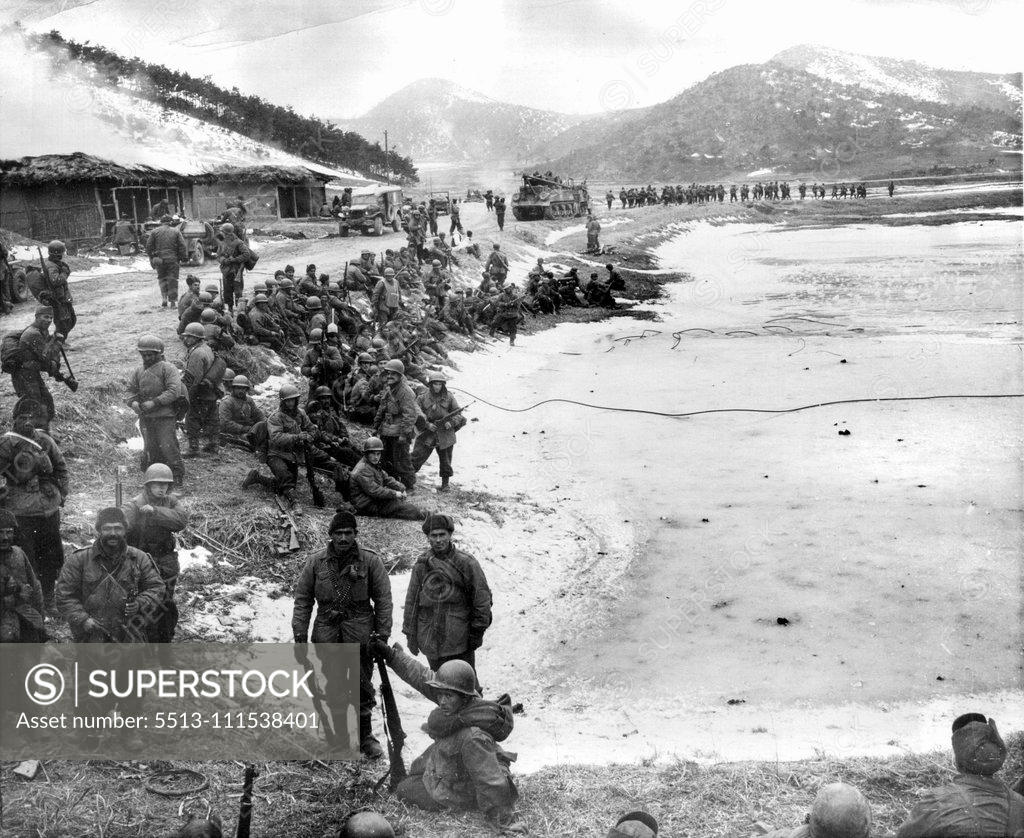 Stock Photo: 5513-111538401 A Day With The 25th (Ninth of Ten) - Turkish troops (background) move up to the front while other turks (foreground) await their turn to relieve American 25th division troops North of Anyang. February 3, 1951. (Photo by ACME).