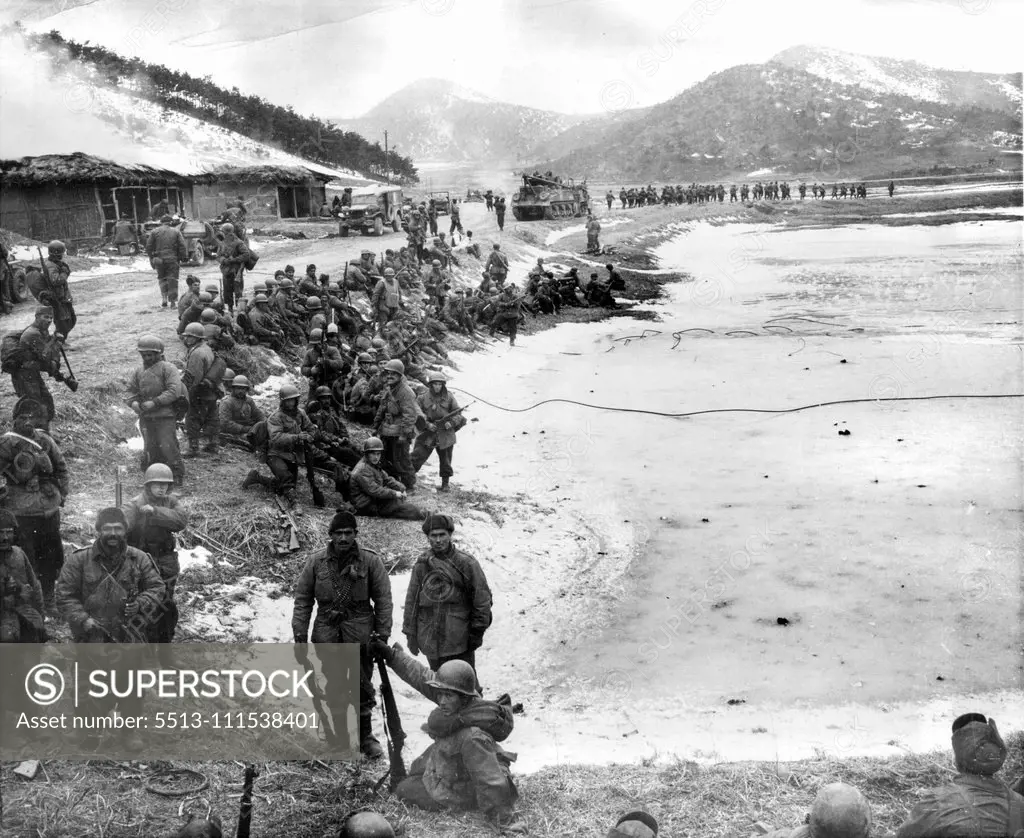 A Day With The 25th (Ninth of Ten) - Turkish troops (background) move up to the front while other turks (foreground) await their turn to relieve American 25th division troops North of Anyang. February 3, 1951. (Photo by ACME).
