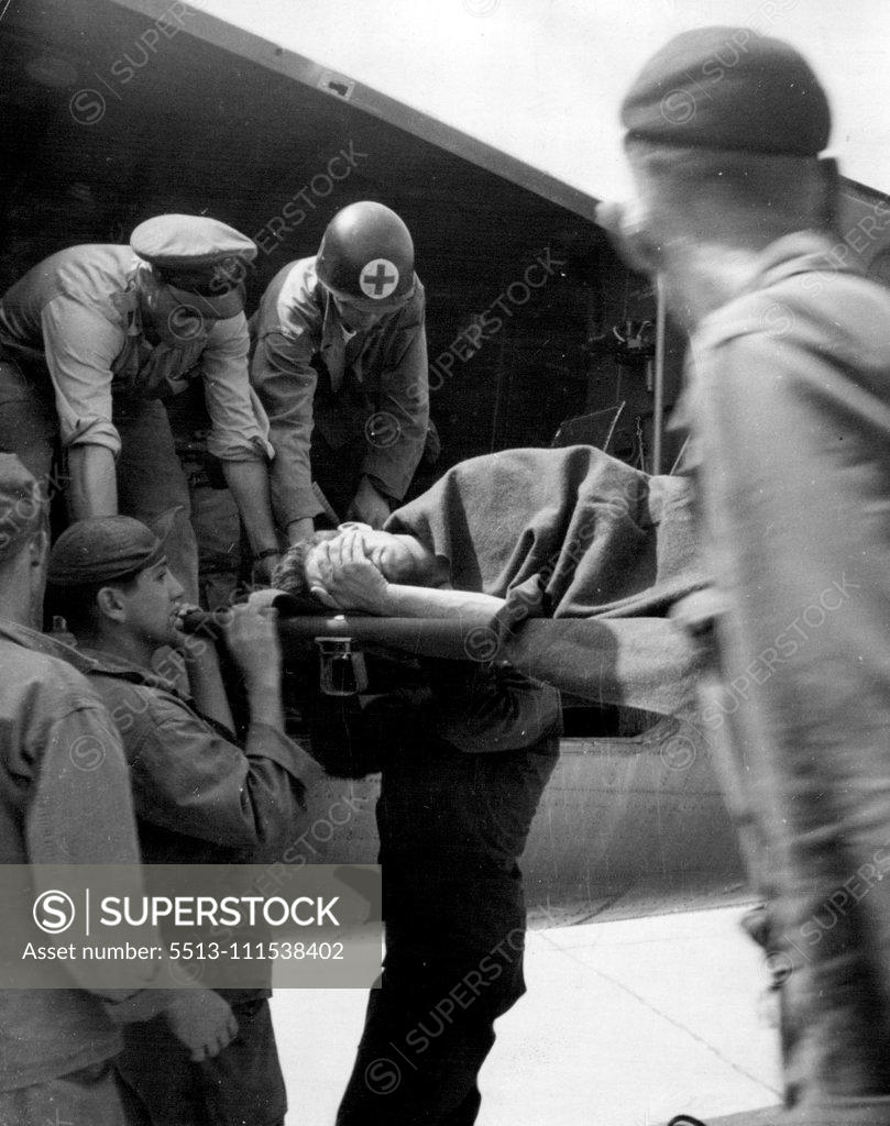 Stock Photo: 5513-111538402 Korean Battle Casualty: Evacuated by air from the battle area in Korea, an American casualty is carried on a stretcher from the ambulance plane at an airport in Japan. July 20, 1950.