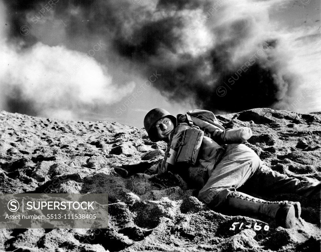Stock Photo: 5513-111538405 Movie Wars Go On: Near Miss! as the actual explosion goes off, film comedian sterling Holloway hugs the earth in this scene from the movie. November 23, 1945. (Photo by ACME).