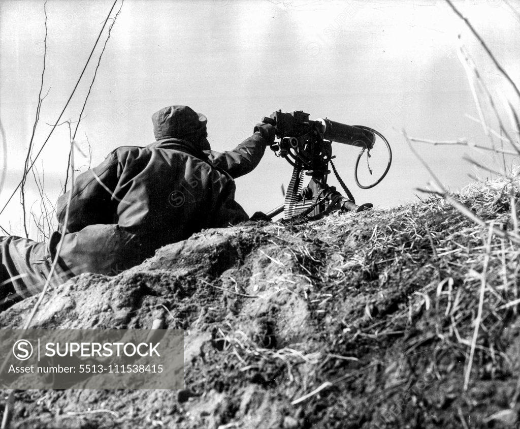 Stock Photo: 5513-111538415 A Day With the 25th (Seventh of Ten) - Two men hold a machine gun position at the crest of a hill, ready to drop down a few feet if enemy fire should spot them. February 3, 1951. (Photo by ACME).