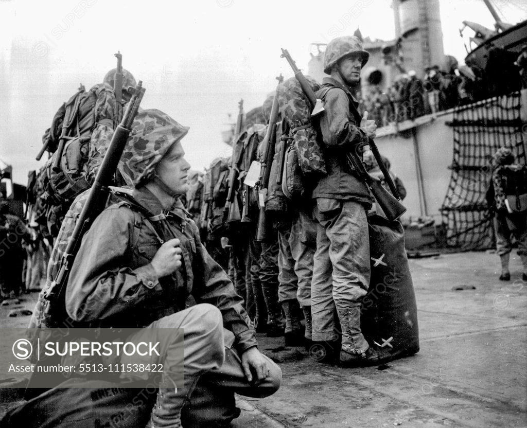 Stock Photo: 5513-111538422 To the Hot War (first of five) - Waitin' for their ship to come in - but this ship carries no dreams of soft and splendid living for the battle-bound marines. Pfc Philip Kreebs of Abilene, Texas, squats on his barracks bag as his buddies stand at east on the pier. November 16, 1951. (Photo by ACME).