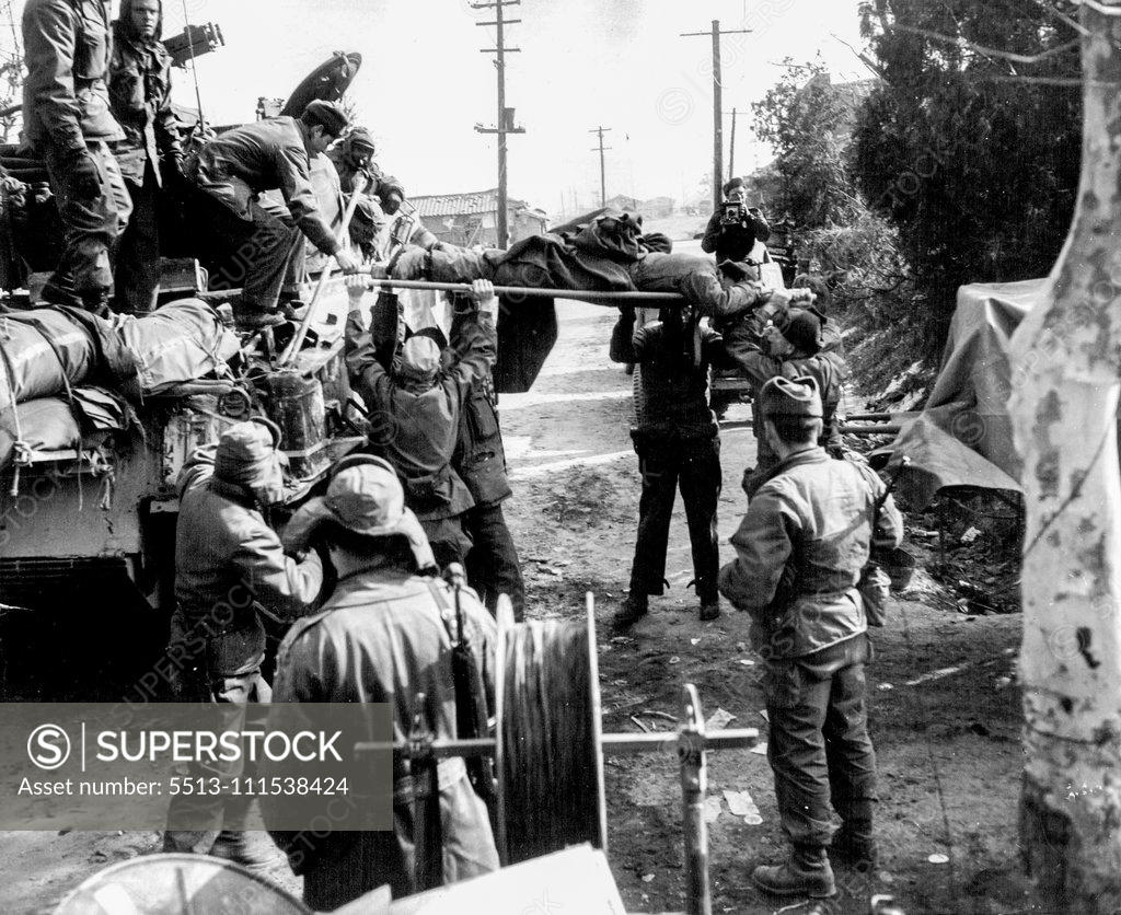 Stock Photo: 5513-111538424 A Day With The 25th (Tenth-End of Set) - More than just this one day's fighting is over for this GI, who is lifted on a stretcher aboard a tank to be taken back to a field Hospital in the Rear. February 3, 1951. (Photo by ACME).