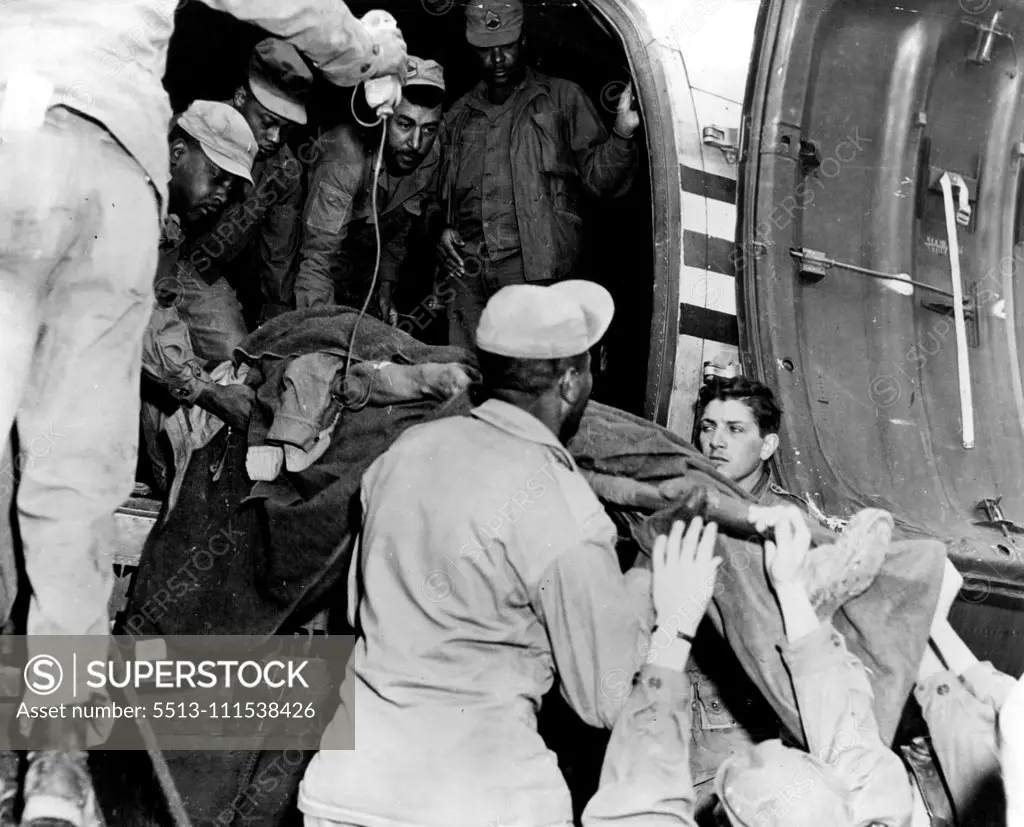United States Soldier, wounded while fighting with ***** forces in Korea, is lifted into a transport airplane at a front-line airstrip in North Korea, to be evacuated to Japan. A medical corpsman (extreme left) administers life-saving blood plasma. Within several hours this soldier was receiving expert medical attention and care at a modern, U.S. Army hospital in northern Japan. December 29, 1950. (Photo by United States Information Service).