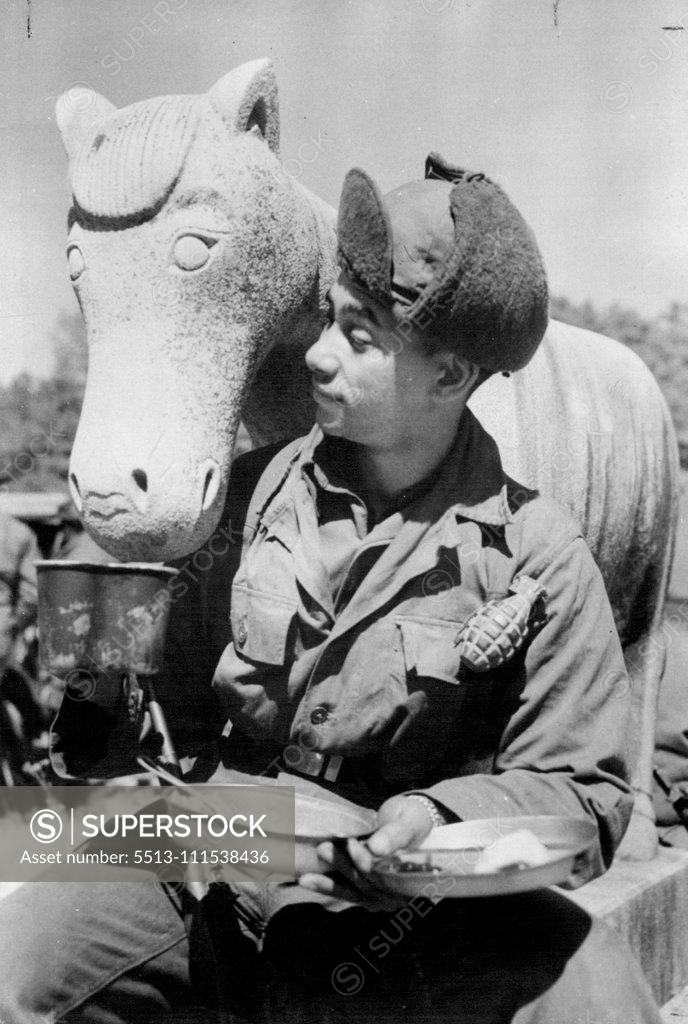 Stock Photo: 5513-111538436 Stony Refusal in Korea: Gentle humour from the grim war scene of Korea is carried by this picture of American infantryman Private (Pirut Class) William E. Kellogg, who offers his coffee to a stone horse standing guard at Kamgong-Ni Temple, 12 miles east of Seoul. The horse maintained a ***** a style favoured by many modern sculptors - le eloquent enough to students of art. April 6, 1951. (Photo by Reuterphoto).