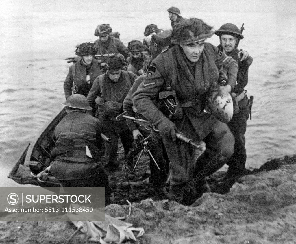 Stock Photo: 5513-111538450 First Across the Rhine: British Infantry Land on East Bank: Men of the Scottish Division led by a Corporal leave their assault craft and double up the east bank of the Rhine to their assembly point. (March 24th). March 28, 1945. (Photo by The Topical Press Agency Ltd.).