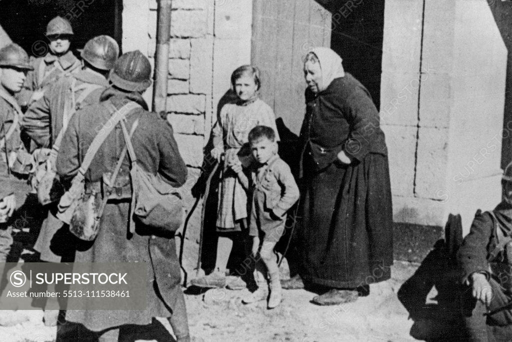 Stock Photo: 5513-111538461 With The French Troops in Germany: An old German peasant woman and her grand children watching French soldiers who captured her village. October 14, 1939. (Photo by Keystone).