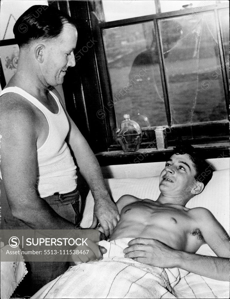 Stock Photo: 5513-111538467 Aid to Fitness - J. Thompson relaxes while he receives attention to his arm muscles after his hot sea bath. April 22, 1946.