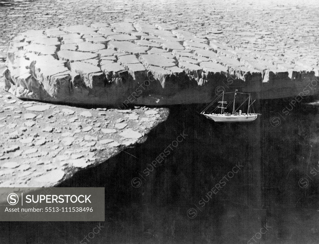 Stock Photo: 5513-111538496 Drifting with the Ice: A remarkable serial view which looks down on to the crevassed surface of iceberg drifting with the pack ice off the ***** of MacRobertson Land, Antarctic. The berg, which has been cast adrift from an intensely crevassed ***** is nearly 200 feet in height. May 12, 1930. (Photo by Captain Frank Hurley, The Herald Feature Service).