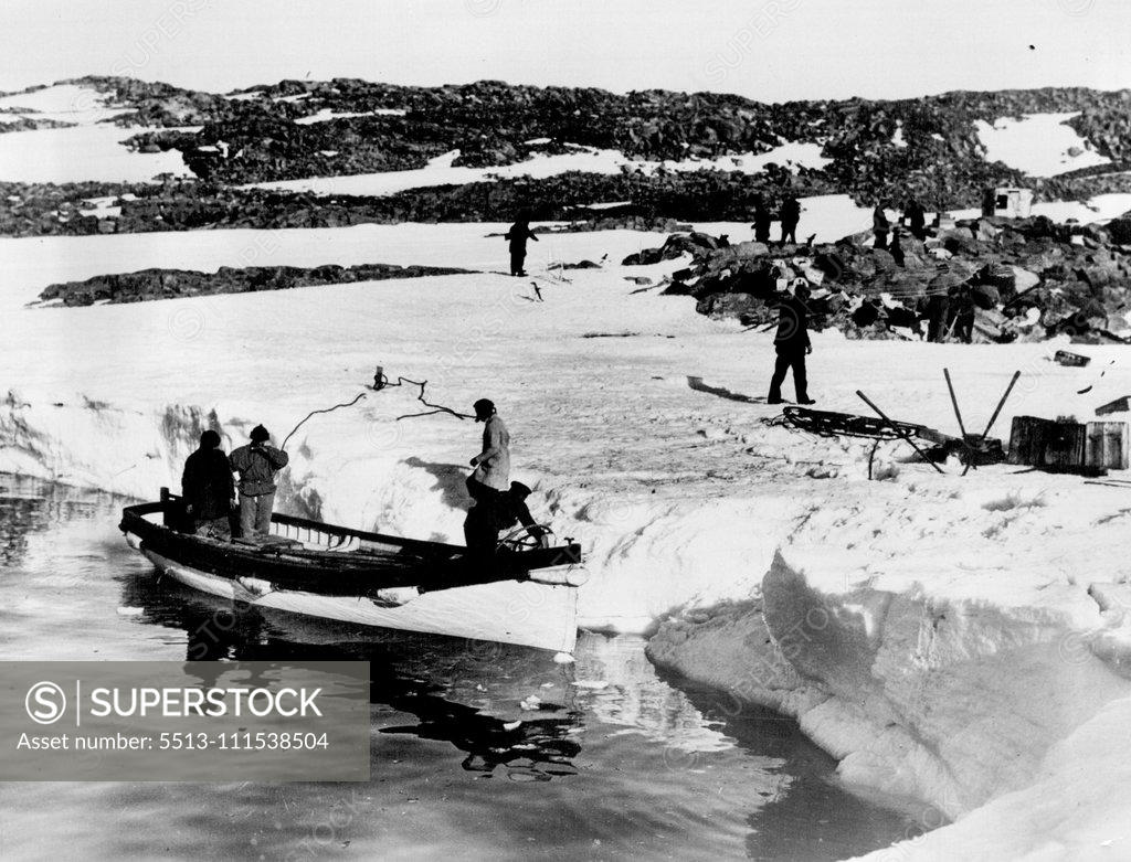 Stock Photo: 5513-111538504 Mawson revisits former winter Quarters. After a lapse of 18 years Sir Douglas Mawson revisited the old winter quarters of his Australian Antarctic Expedition of 191101914. A landing is being made at Cape Denison, King George the Fifth Land. May 19, 1931. (Photo by Captain Frank Hurley, Herald Feature Service).