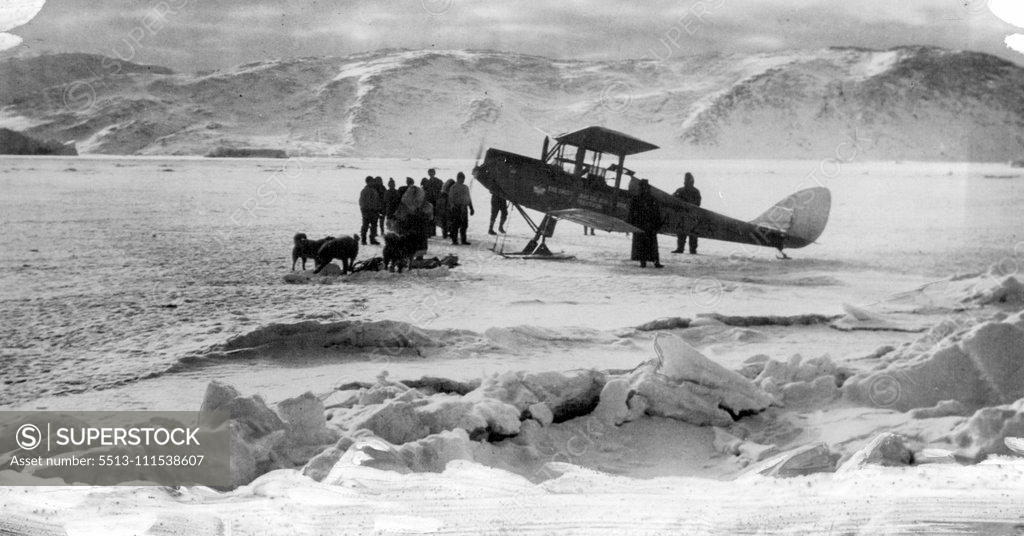 Stock Photo: 5513-111538607 British Arctic Air Route Expedition: An expedition aeroplane on ski on the ice near the Base. In foreground can be seen the rough tide-foot ice, where the sea meets the land. Taken about May 1931. December 28, 1931. (Photo by British Arctic Air Route Expedition Photograph).