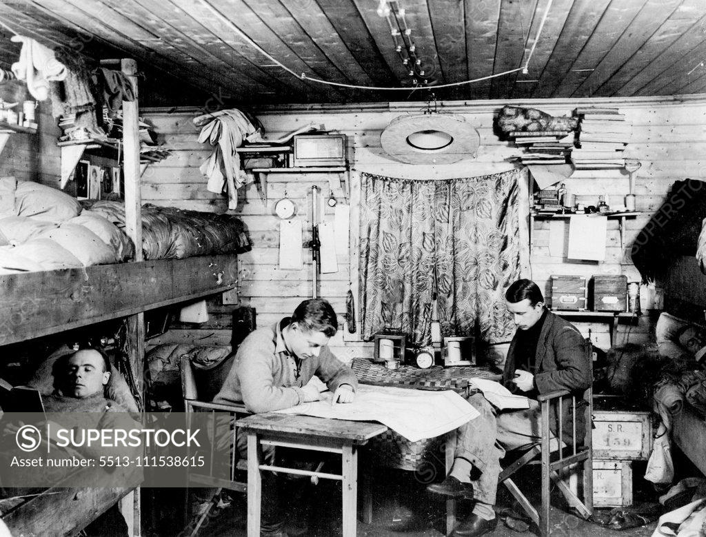 Stock Photo: 5513-111538615 British Arctic Air Route Expedition: A flashlight photograph taken by Ft. Lt. Cozens showing the main room of the hut at the Base Camp. L to R - Bingham, Stephenson, Riley and D'Aeth. July 30, 1931. (Photo by British Arctic Air Route Expedition Photograph).