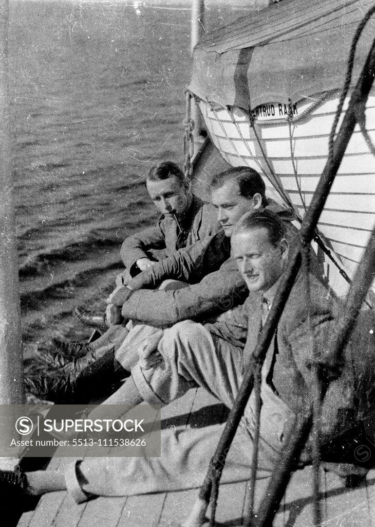 Stock Photo: 5513-111538626 British Arctic Air Route Expedition: On board the Gertrud Rask - Mr. H. G. Watkins, the leader of the expedition, who lost his life in an accident to a kayak (nearest the camera), with Mr. J. R. Rymill and Mr. Quintin Riley, two other members of the expedition. November 11, 1932. (Photo by British Arctic Air Route Expedition Photograph).