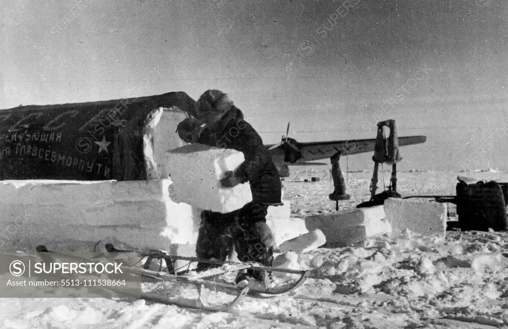 The Soviet Station on the North Pole: Ivan Papanin, chief of the drifting station ***** North Pole, packing ice around ***** of the tents of the station. June 1, 1937. (Photo by Soyuzphoto).