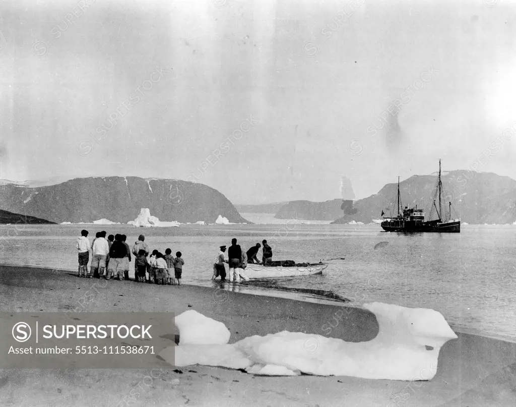 Ellesmere Land Expedition: "The Signalhorn" anchored in Robertson Bay with group of Eskimos looking on. November 26, 1934.