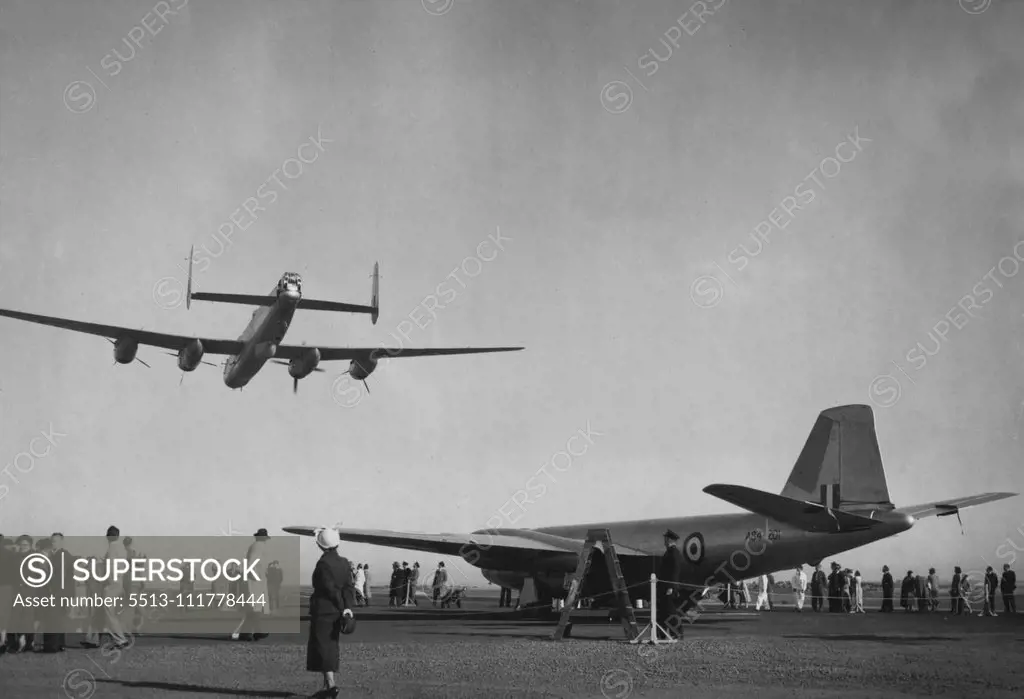First Australian-Built Canberra Jet Bomber stands on the Avalon airstrip near Geelong today before its first official flight. Overhead an Australian built Lincoln bomber demonstrates flying on one engine. The propeller second from the right is the only one rotating. June 29, 1953.