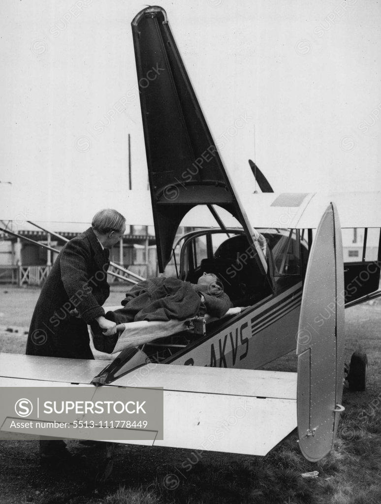 Stock Photo: 5513-111778449 Demonstrating The Sky Jeep... Fuselage Life Up To Take Streetweek Case. Showing how the fuselage lifts to make way for the stretcher and stretcher Case in the new "Sky Jeep". The test pilot Mr. D. Lowry "Leads" the aircraft. A demonstration is being held at London Airport for ***** new Chrislea "Sky Jeep" - a tiny machine for tilitarian use.... The machine is fitted with a 155 H.. Cirrus Major 111 engine and has accommodation for four seats, with provision for two occasional seats for children