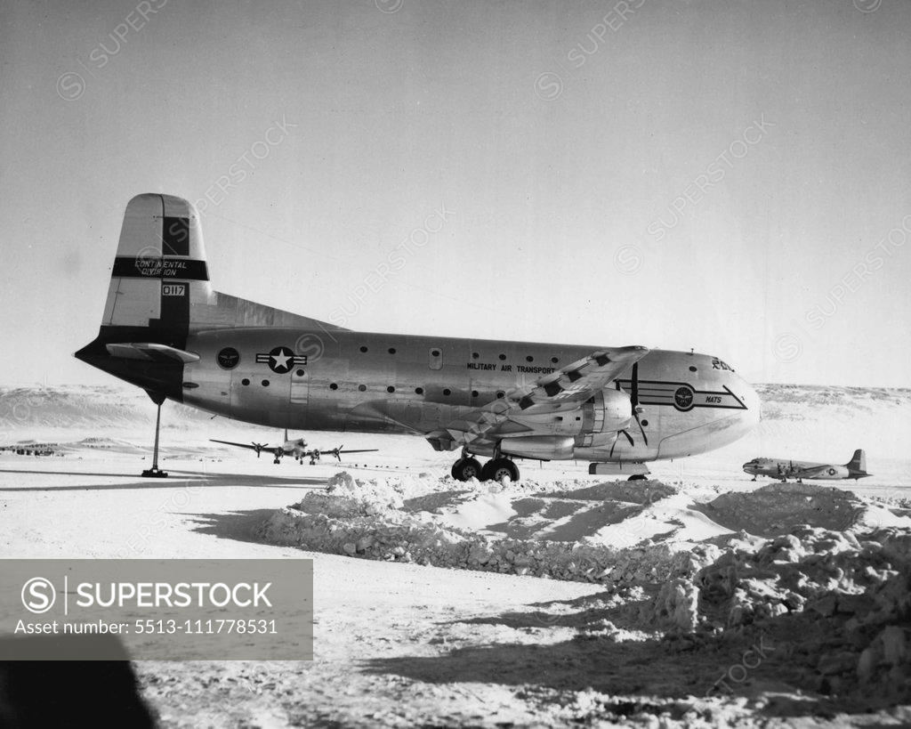 Stock Photo: 5513-111778531 Resupply Transports. A Military Air Transport Service C-124 Transport plane dwarfs two 4-engine C-54s used in airlifting supplies and equipment to personnel building the air base, at Thule, Greenland. September 18, 1952. (Photo by Official Air Force Photo).