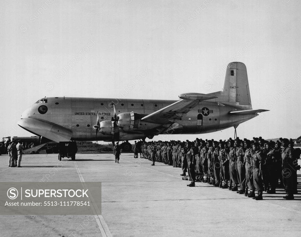 Stock Photo: 5513-111778541 C-124 Globemaster to Participate in "Operation Handclasp" A C-124 Globemaster of the 315th Air Division stands by on a flight line in Japan as United Nations soldiers are given a pre-flight briefing. Two of the giant C-124s will participate in -Operation Handclasp II", a goodwill and training flight from Japan to Australia. The C-124s will be used to airlift maintenance equipment and support personnel and will be placed on static display at several Australian airbases. February 23, 1955. (Photo
