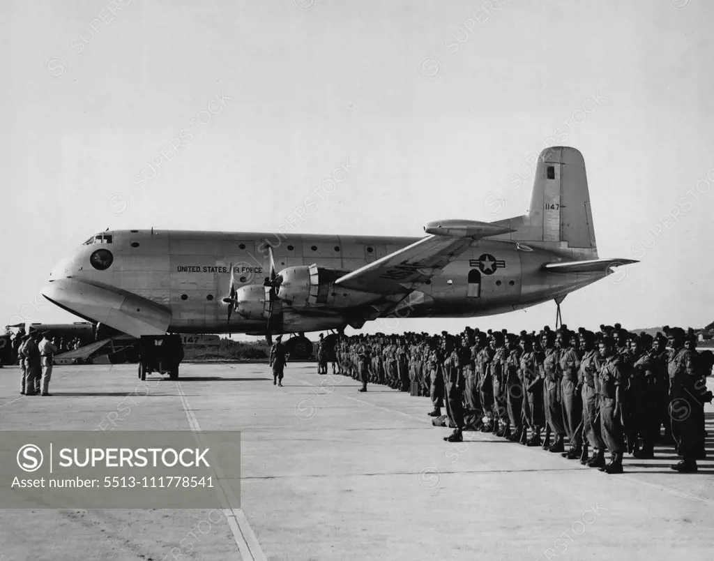 C-124 Globemaster to Participate in "Operation Handclasp" A C-124 Globemaster of the 315th Air Division stands by on a flight line in Japan as United Nations soldiers are given a pre-flight briefing. Two of the giant C-124s will participate in -Operation Handclasp II", a goodwill and training flight from Japan to Australia. The C-124s will be used to airlift maintenance equipment and support personnel and will be placed on static display at several Australian airbases. February 23, 1955. (Photo