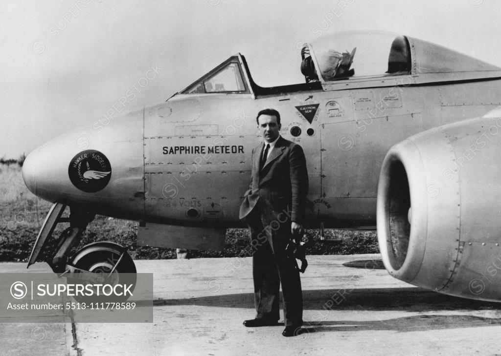 Stock Photo: 5513-111778589 Collected Climbing Records. Wearing an ordinary lounge suit and regulation flying helmet, Flight- Lieutenant R.B. ("Tom") Prickett, 29-year-old test pilot is pictured before stepping into the plane behind him - the Hawker Siddeley Sapphire Meteor twin jet aircraft in which he collected four world records for Britain. Flying from the aerodrome here the aircraft climbed to 39,600 feet, or nearly seven and & half miles, in three minutes seven seconds. Other records scooped up by the Meteor were 9,8