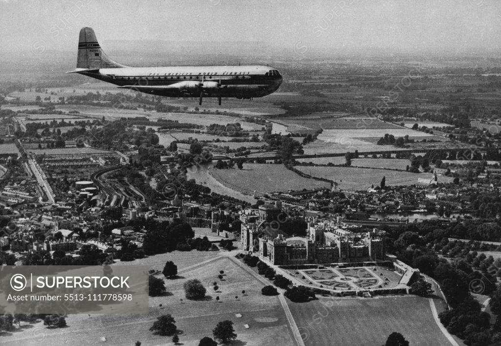 Stock Photo: 5513-111778598 The Span of A Thousand Years Nearly a thousand years of history glides under the majestic wings of this Pan American 'Stratocruiser', world's largest aeroplane in commercial service, as she passes over Windsor Castle en route to London Airport from New York. Beneath the 'Stratocruiser' the Castle - a Royal residence since the days of William the Conqueror (although it was built mainly by Henry III) - spreads its gracious grey bulk on the banks of the River Thames, winding through the chequered B