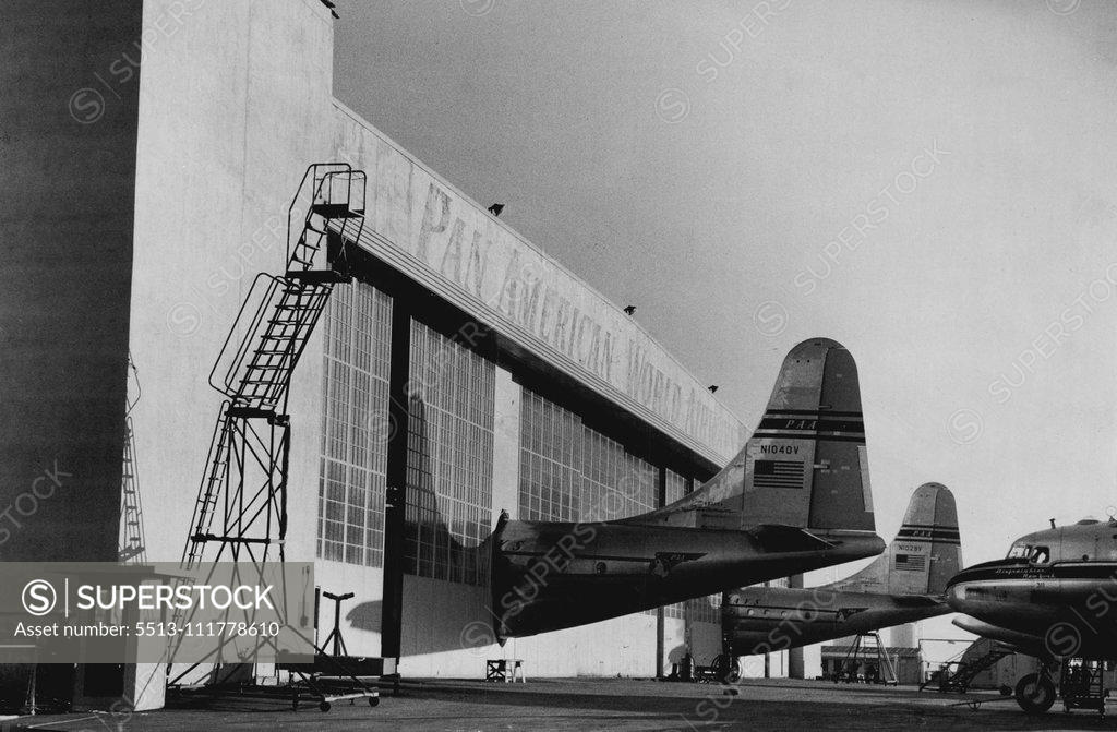Stock Photo: 5513-111778610 Even The Big hangars at San Francisco are too small for the new giant Pan-American Strato Clippers. To solve the problem, special holes were made made in the doorways. This picture was secured by a Sun photographer who has just returned from US. March 15, 1951.