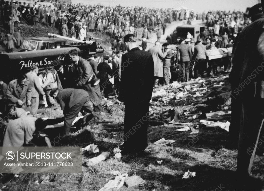 Stock Photo: 5513-111778623 When Death From The Air Struck The Farnborough Hillside On the hillside after Derry's engine had struck. Casualties are being removed on stretchers. In foreground (left) a woman is receiving attention. Twenty persons - pilot John Derry and a passenger and 18 spectators were killed and 35 spectators were injured when the No. 1 prototype of the semi-secret De Havilland 110 all-weather jet fighter blew up at the Farnborough (Hampshire) air show today (Saturday). The spectators were on a hillside st