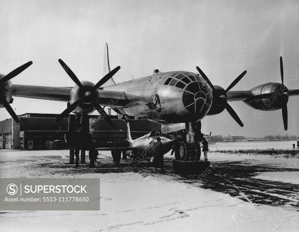 Stock Photo: 5513-111778650 A new method of attaching experimental research aircraft to mother ships is shown here at Bell Aircraft Corp.'s Niagara Falls plant. The B-29 mother ship is raised on hydraulic hoists and, in this instance, the Bell X-1A is moved under the B-29 to be attached to the fuselage of the four-engine plane. Previous Bell X-1 airplanes were attached from a pit beneath the mother airplane. April 10, 1953. (Photo by Bell Aircraft Corporation).