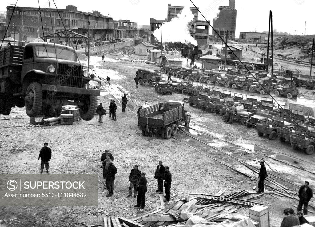 Stock Photo: 5513-111844589 UNRRA jeeps and trucks being landed at No.5 Quay at Piraeus. They are some of the 3500 trucks and over 300 jeeps which UNRRA Greece Mission has imported from the U.S. Army in Italy. By the end 1945 UNRRA had brought in all 5000 trucks, 320 jeeps, 112 motorcycles, 10000 tires and 1500 cases of spare parts into Greece. August 5, 1947. (Photo by UNRRA Photo).;UNRRA jeeps and trucks being landed at No.5 Quay at Piraeus. They are some of the 3500 trucks and over 300 jeeps which UNRRA Greece Mission h