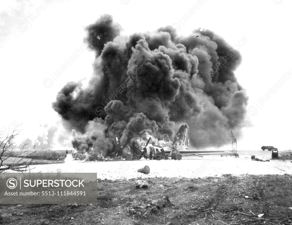 Stock Photo: 5513-111844591 B-29 Burns After Jap Attack on Saipan - An American B-29 superfortress burns on Saipan Island, in the Marianas, after Jap planes strafed the airfield. December 27, 1944. (Photo by Associated Press Photo).;B-29 Burns After Jap Attack on Saipan - An American B-29 superfortress burns on Saipan Island, in the Marianas, after Jap planes strafed the airfield.