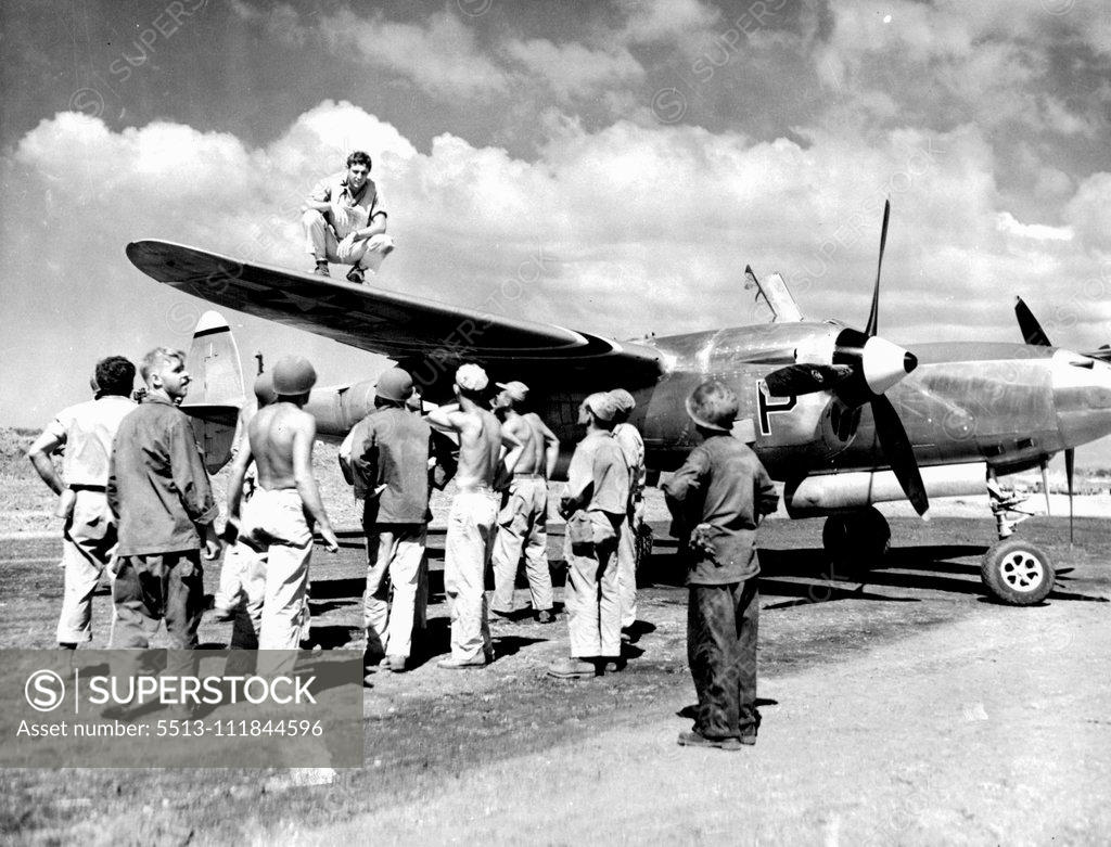 Stock Photo: 5513-111844596 H.B. Graham of Yucaipa, Calif., Squatting on wing of his P-30, and ground crew men look over bullet holes which forced him down after he had knocked one Zero down and damaged another over Mindoro, Philippine Island. January 22, 1945. (Photo by U.S. Army Signal Corps Photo).;H.B. Graham of Yucaipa, Calif., Squatting on wing of his P-30, and ground crew men look over bullet holes which forced him down after he had knocked one Zero down and damaged another over Mindoro, Philippine Island.