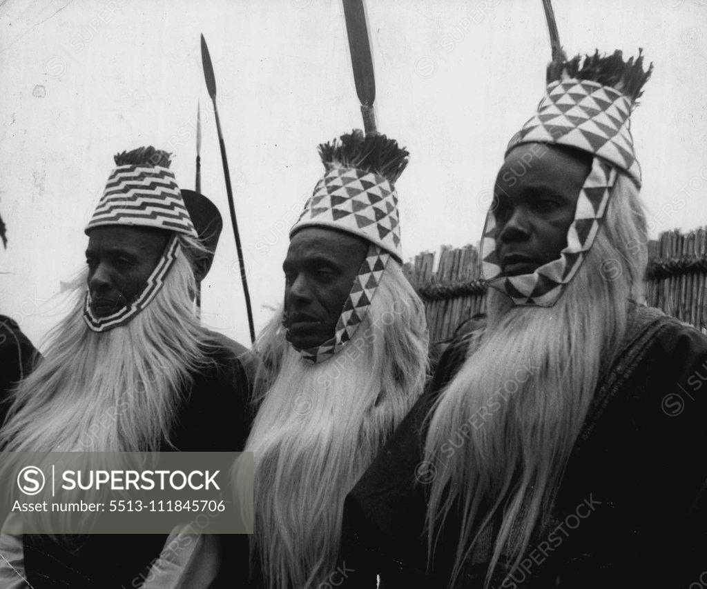 Stock Photo: 5513-111845706 Uganda Native Ruler's Silver Jubilee -- Close-up of the leading chiefs, similarly garbed in ekondos (crowns), beards made from the fur of a colobus monkey, and hats of ornamental beads fringed with red feathers from a parrot's tail, who attended the Silver Jubilee celebrations. February 13, 1951, (Photo by Camera Press). ;Uganda Native Ruler's Silver Jubilee -- Close-up of the leading chiefs, similarly garbed in ekondos (crowns), beards made from the fur of a colobus monkey, and hats of ornamen