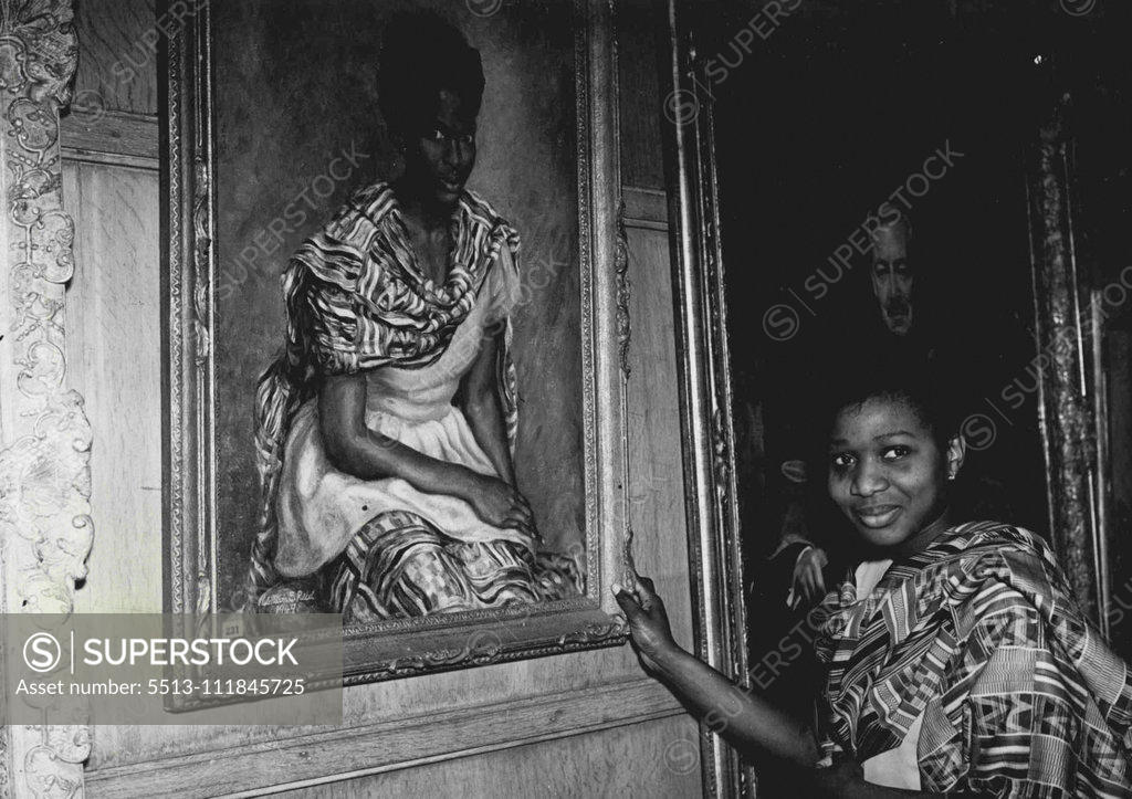 Stock Photo: 5513-111845725 Hopes Father Will Buy Her Picture -- Frances Quashie-Idun, 21, brought a gay West African costume to wear at parties and dances when she came to Britain from her home at Accra, Gold Coast. But for most of the time she has worn the costume she has been sitting quite still while artist William E. Reid painted her. The portrait is hanging in the Piccadilly, London, exhibition of the Royal society of Portrait painters. Frances, studying English at University College, Oxford, hopes her father a Gold 