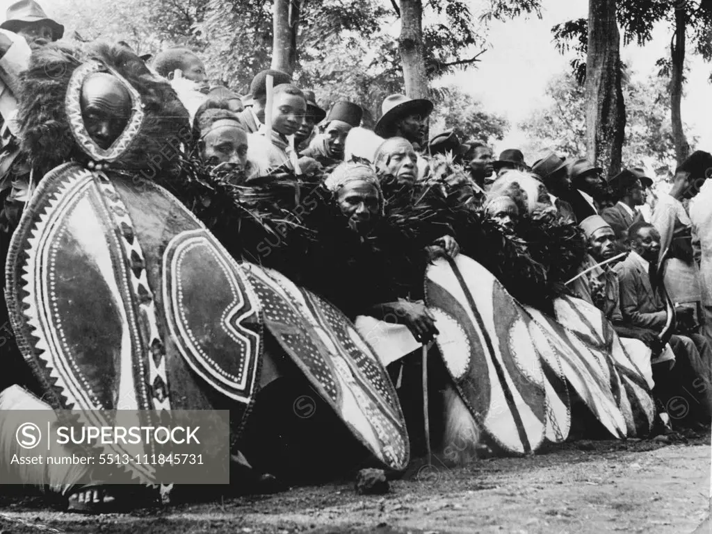 Cambridge-Trained African Chief -- Chief Thomas Marealle of the Chagga Tribe: Chagga singers in traditional dress wait to perform their part in the ceremony. January 28, 1955. (Photo by Central Office of Information Photograph).;Cambridge-Trained African Chief -- Chief Thomas Marealle of the Chagga Tribe : Chagga singers in traditional dress wait to perform their part in the ceremony.