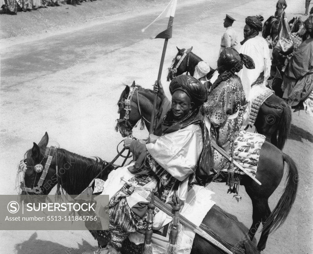 Stock Photo: 5513-111845756 In magnificent apparel these warriors were among the 7,000 ian tribesman who paraded before the Queen at yesterday's (2-2-56) Durbar at Kaduna. February 17, 1955. (Photo by Daily Mirror).;In magnificent apparel these warriors were among the 7,000 ian tribesman who paraded before the Queen at yesterday's (2-2-56) Durbar at Kaduna.