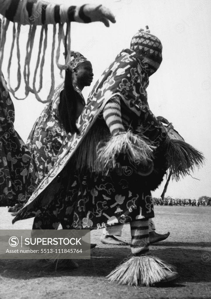 Stock Photo: 5513-111845764 His head completely covered and clad in a colorful dress trimmed with straw this ian tribesman was among the 7,000 who paraded before the Queen at the Kaduna rally on Thursday (2-2-56). February 17, 1955. (Photo by Daily Mirror).;His head completely covered and clad in a colorful dress trimmed with straw this ian tribesman was among the 7,000 who paraded before the Queen at the Kaduna rally on Thursday (2-2-56).