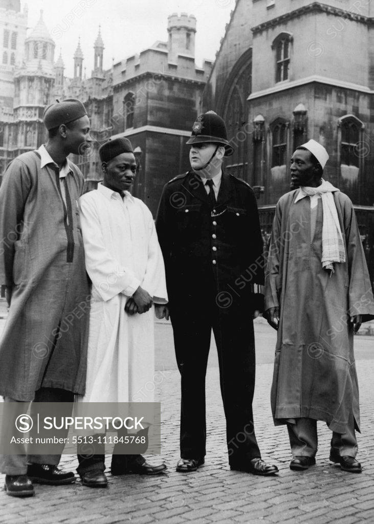 Stock Photo: 5513-111845768 African Visitors In London -- Left to right:- Sani Ahmed, Sulymann Bomai, Shehu Maska, the last two come from ia, seen talking to a Policeman outside the Houses of Parliament this morning. Eight Ugandan Chief and nine Northern ian administrators who are visiting the United Kingdom for six weeks, under arrangements made by the British Council at the request of their governments, are visiting places of interest in London during the next 10 days. September 30, 1955. (Photo by Fox Photos).
